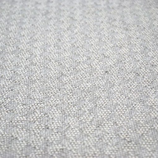 detail of a throw pillow in grey color