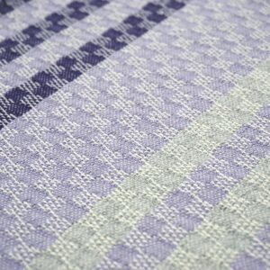 detail of a purple and grey striped cotton decorative pillow